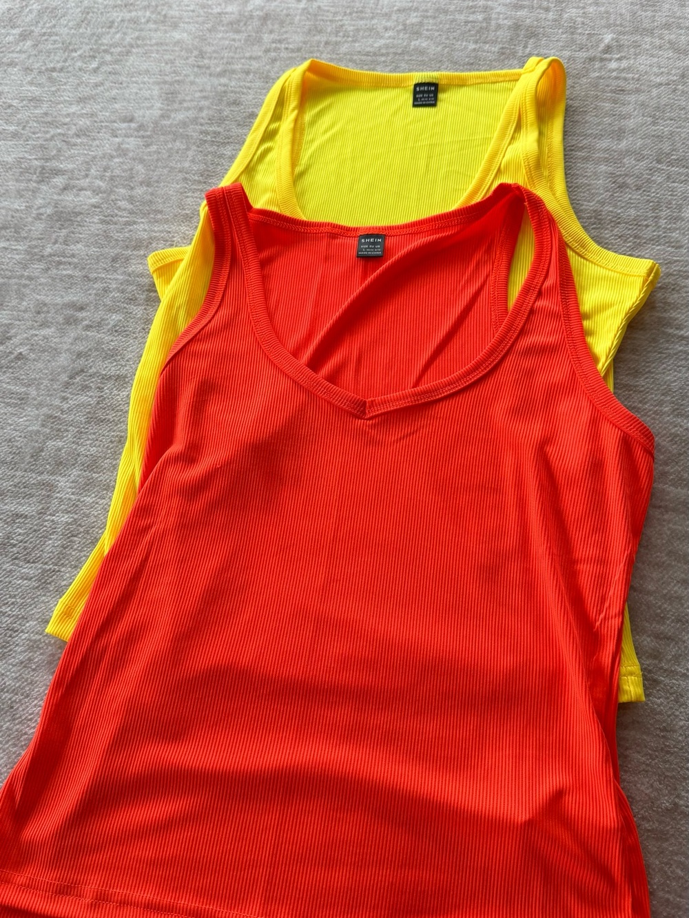 2 tanks in vibrant orange and yellow